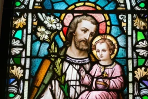 Stained glass image of St. Joseph with the child Jesus | Photo by Josh Applegate on Unsplash
