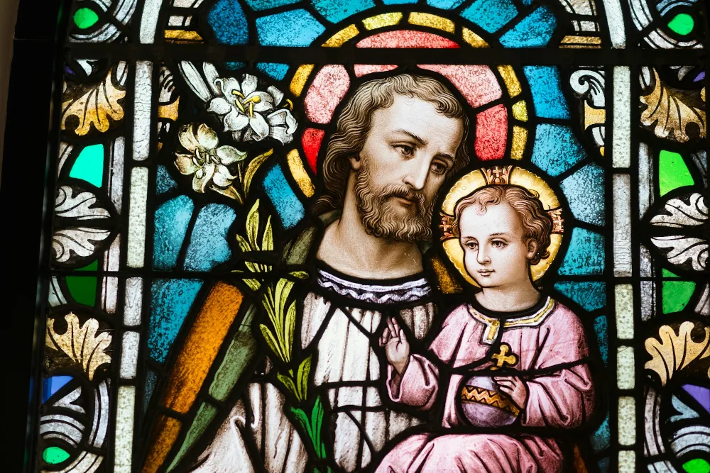 Stained glass image of St. Joseph with the child Jesus | Photo by Josh Applegate on Unsplash