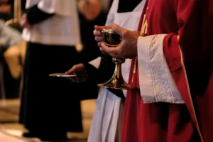 Priest holding chalice | Photo by Julia Michelle on Unsplash